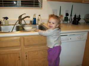 100_0048 Lexi after dinner "doing the dishes"