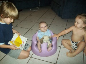 Zander reading Brown Bear to his siblings